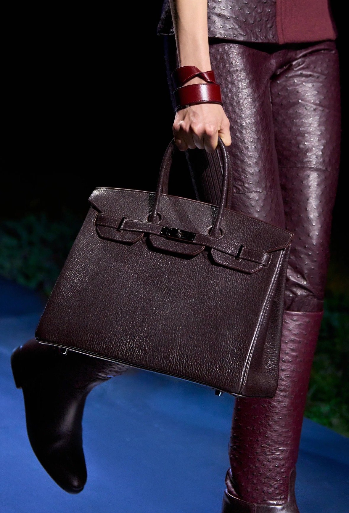 Deep burgundy handbag carried with a burgundy outfit