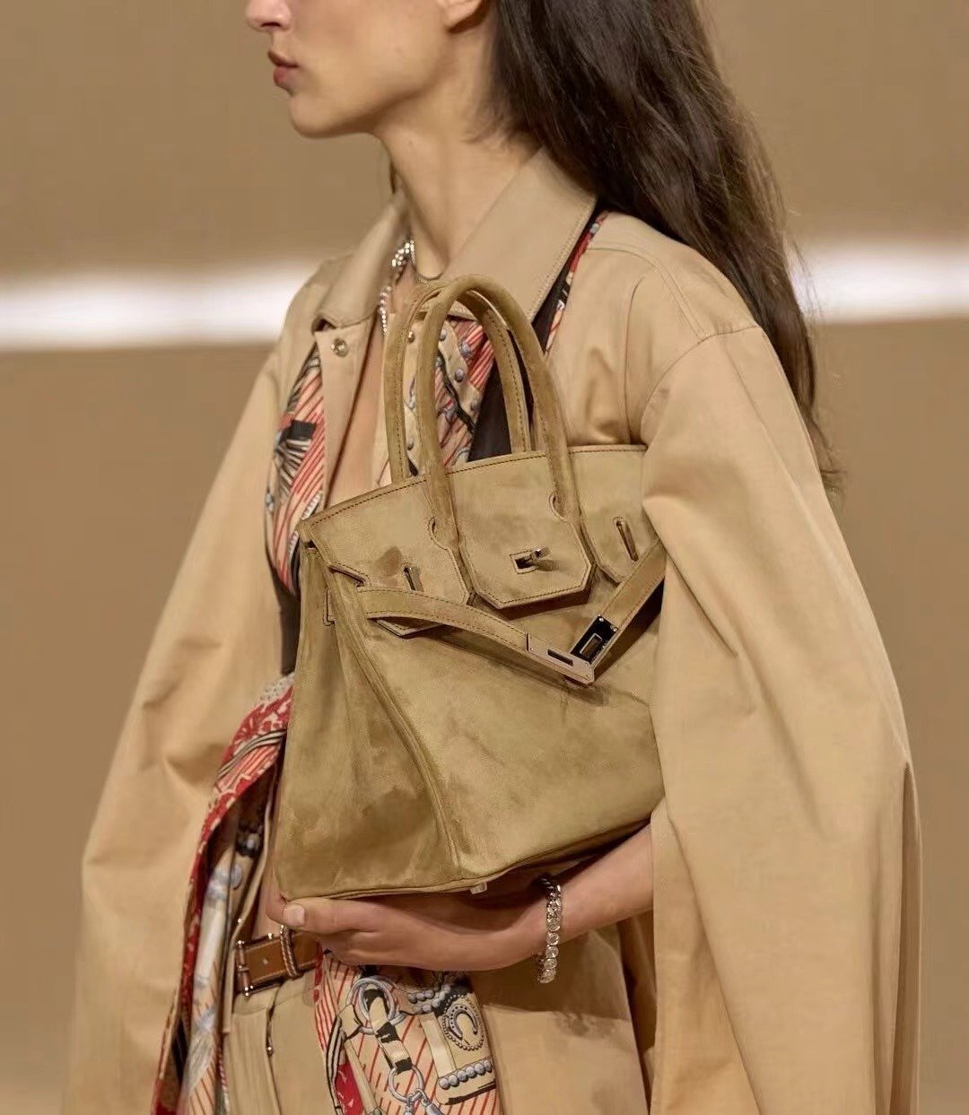 Tan handbag styled with a neutral outfit