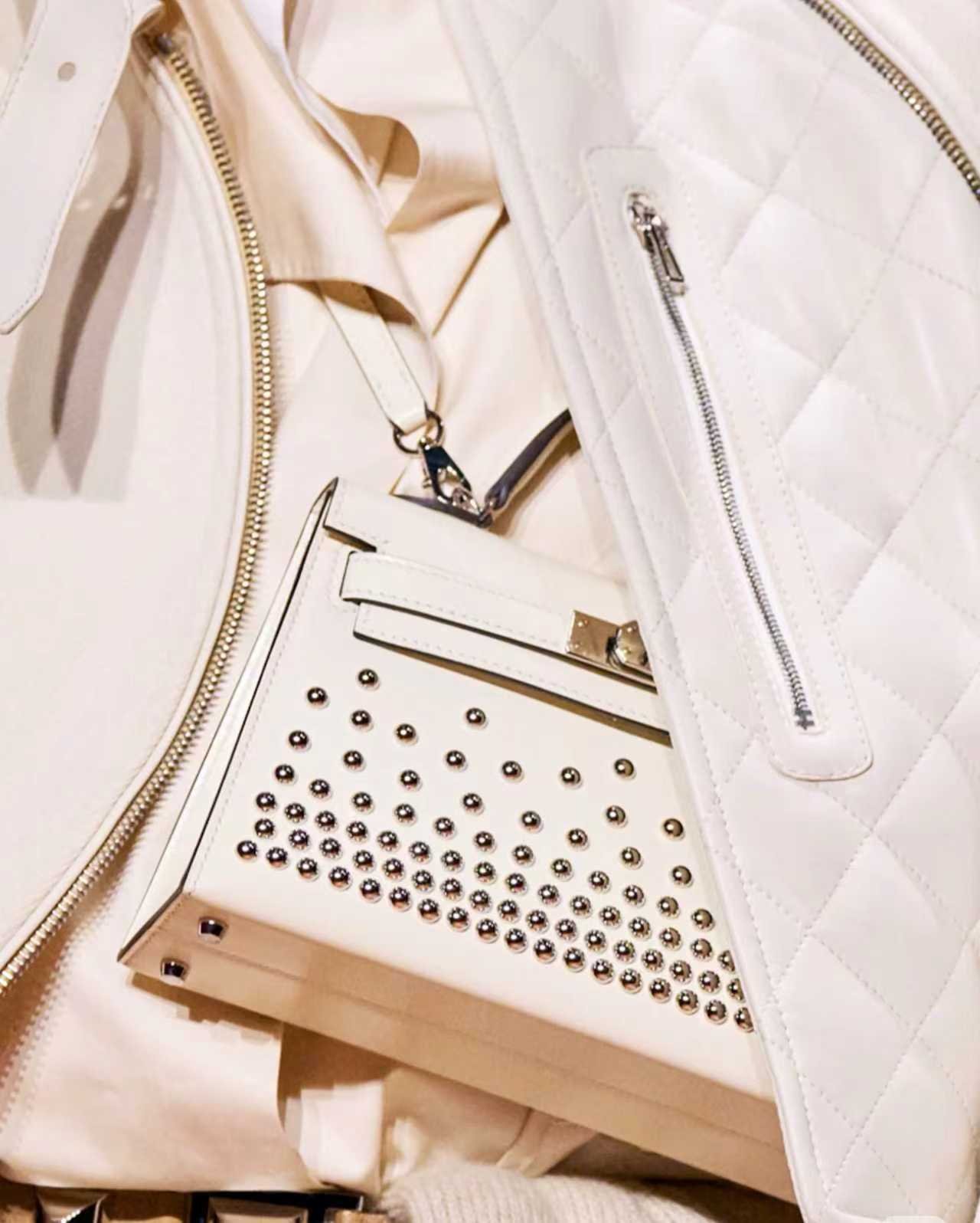 White handbag with metallic stud details